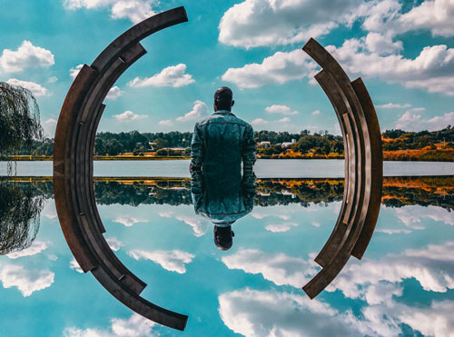 man standing near body of water